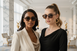 2 women wearing pas jalou sunglasses, in a luxury hotel setting
