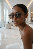 Woman wearing PAS JALOU  sunglasses in a modern indoor setting