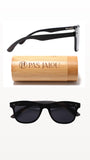 Classic black sunglasses with dark lenses, displayed with a bamboo case and accessories