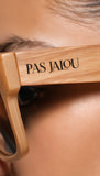 Close-up of sunglasses with 'PAS JALOU' branding 