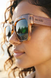 Person wearing leopard sunglasses with 'PAS JALOU' brand name.